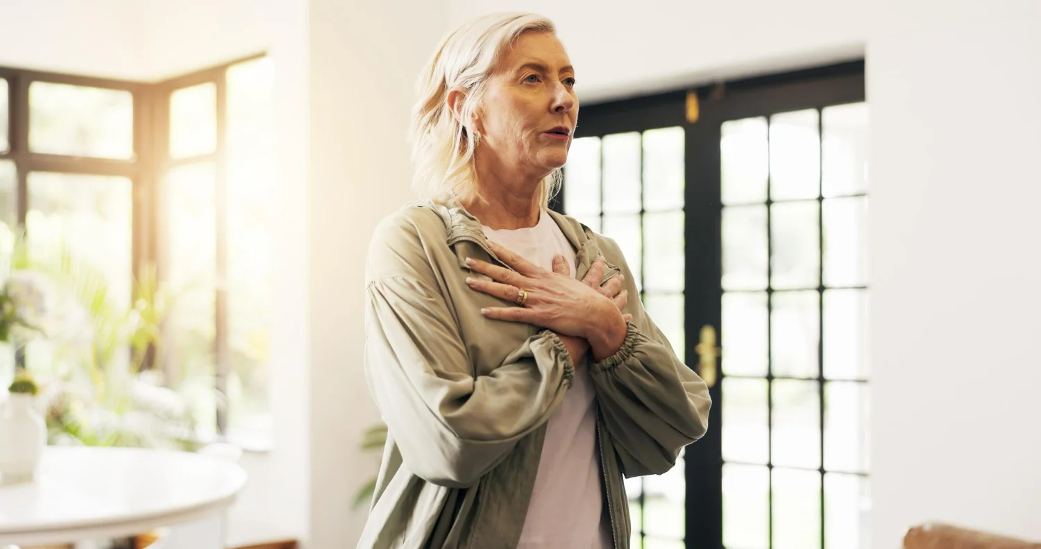 Idosa coloca as mãos no coração ao sentir um sopro no coração